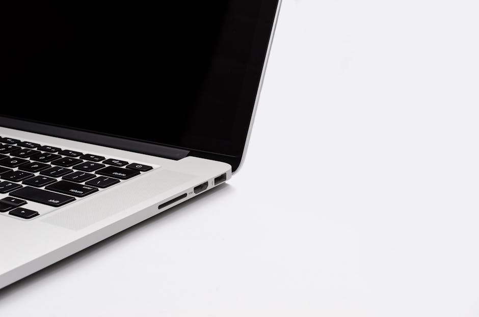 Closeup of a sleek laptop keyboard and screen on a white background. Perfect for tech-related content.